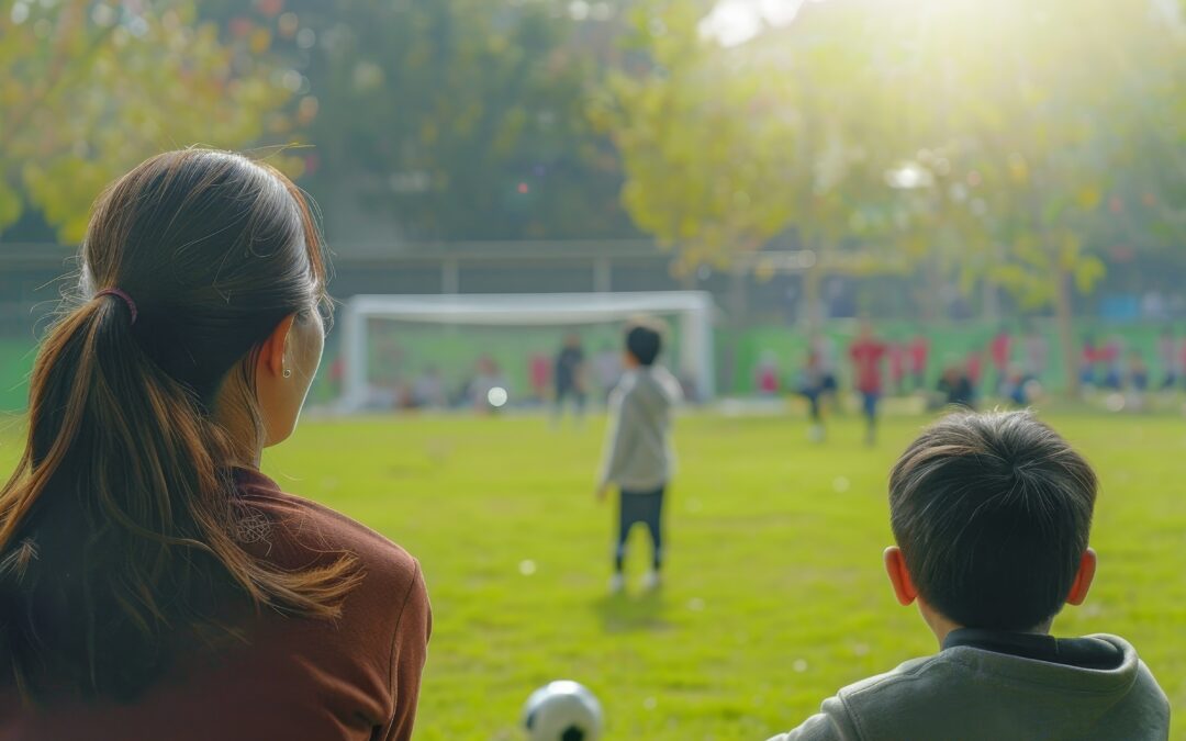 Parents observing their children participate in a school football tournament providing support and motivation